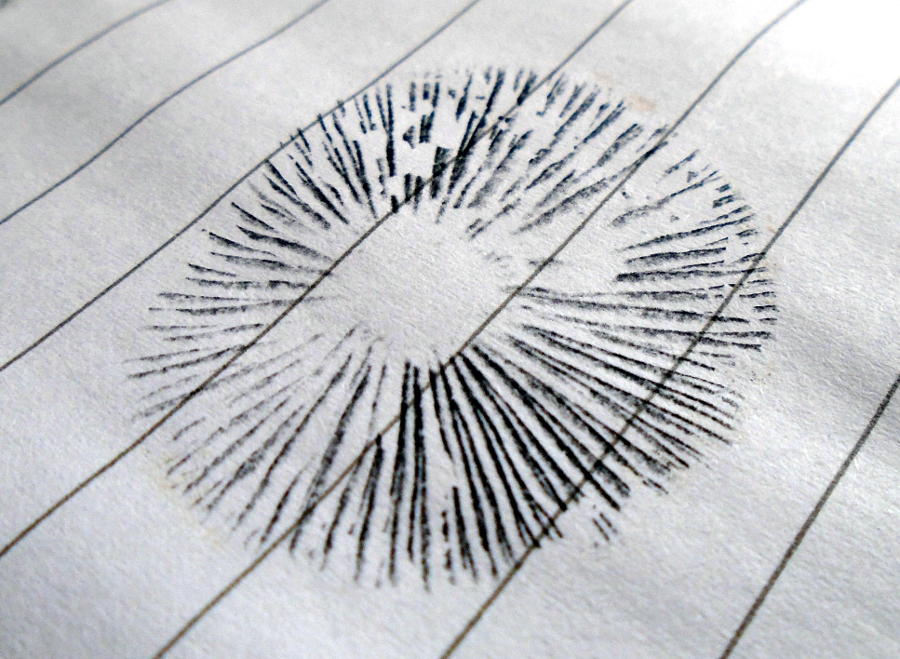 Black sporeprint on white, ruled paper