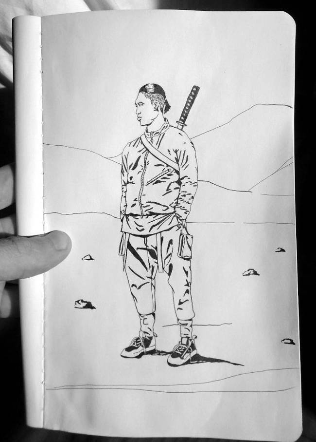 Pen and ink drawing of a man standing with his hands in his pockets. He has a katana slung across his back and there are rocks scattered around and hills in the background